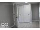 Bright bedroom with new flooring and double doors leading to closet at 231 S Routiers Ave, Indianapolis, IN 46219