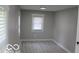 Small bedroom with gray walls and vinyl flooring at 231 S Routiers Ave, Indianapolis, IN 46219