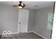 Bedroom with ceiling fan, gray walls and carpet at 231 S Routiers Ave, Indianapolis, IN 46219