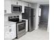 Stainless steel appliances and white shaker cabinets in kitchen at 231 S Routiers Ave, Indianapolis, IN 46219