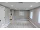 Bright living room with light gray walls and wood-look floors at 231 S Routiers Ave, Indianapolis, IN 46219