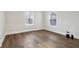 Bright bedroom featuring hardwood floors, white walls, and windows with coverings at 2521 Prospect St, Indianapolis, IN 46203