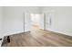 Bright bedroom featuring hardwood floors, white walls, and windows with coverings at 2521 Prospect St, Indianapolis, IN 46203
