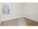 Small bedroom featuring wall-to-wall carpeting, white walls, and window with coverings at 2521 Prospect St, Indianapolis, IN 46203