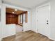 Front entryway with hardwood floors, a white front door, and wood paneling at 2521 Prospect St, Indianapolis, IN 46203