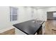 Close-up of a kitchen island with stainless steel sink and black countertops at 2521 Prospect St, Indianapolis, IN 46203