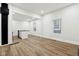 Spacious living area featuring light wood floors, white trim, and a partial view of the kitchen at 2521 Prospect St, Indianapolis, IN 46203
