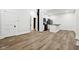 Open-concept living room with light wood floors flowing into the kitchen space at 2521 Prospect St, Indianapolis, IN 46203