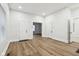 Open living room with light wood floors and multiple doorways at 2521 Prospect St, Indianapolis, IN 46203