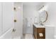 Modern bathroom with gold fixtures and a wood vanity at 454 Tulip Dr, Mooresville, IN 46158