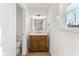 Small bathroom with wood vanity, gold fixtures, and a floating shelf at 454 Tulip Dr, Mooresville, IN 46158