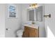 Modern bathroom with a wood vanity, gold fixtures and a large mirror at 454 Tulip Dr, Mooresville, IN 46158
