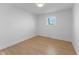 Simple bedroom with light wood floors and a window at 454 Tulip Dr, Mooresville, IN 46158