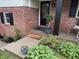 Inviting front entrance with brick exterior, black accents, and a welcoming 'welcome' mat at 454 Tulip Dr, Mooresville, IN 46158