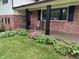 Charming front porch with brick facade, black shutters, and a cozy rocking chair at 454 Tulip Dr, Mooresville, IN 46158