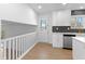 Bright kitchen with white cabinets, hardwood floors, and access to deck at 454 Tulip Dr, Mooresville, IN 46158