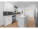 Modern kitchen featuring white cabinets, quartz countertops, and stainless steel appliances at 454 Tulip Dr, Mooresville, IN 46158
