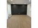 Living room featuring a dark accent wall and hardwood floors at 454 Tulip Dr, Mooresville, IN 46158