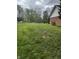 Expansive side yard with lush green grass surrounded by mature trees; a beautiful outdoor space at 454 Tulip Dr, Mooresville, IN 46158