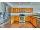 Kitchen with stainless steel appliances and wood cabinets at 5701 Brookstone Dr, Indianapolis, IN 46234