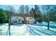 Ranch home with attached garage, snowy landscape, aerial view at 6361 Crystal Springs Dr, Avon, IN 46123
