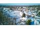 Aerial view of neighborhood with pond and homes covered in snow at 6361 Crystal Springs Dr, Avon, IN 46123