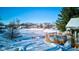 Frozen pond view with home, deck and pool visible during a snowy day at 6361 Crystal Springs Dr, Avon, IN 46123