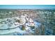 Neighborhood view showcasing homes and a pond blanketed in snow at 6361 Crystal Springs Dr, Avon, IN 46123