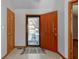 Bright entryway with tiled floor and an orange front door at 6361 Crystal Springs Dr, Avon, IN 46123