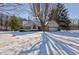 Brick ranch home with attached garage, nestled on a snowy lot at 6361 Crystal Springs Dr, Avon, IN 46123