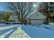 Tan brick ranch home with attached two car garage, winter view at 6361 Crystal Springs Dr, Avon, IN 46123