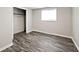 Bedroom featuring wood-look floors, closet, and a window that provides natural light at 715 N Warman Ave, Indianapolis, IN 46222