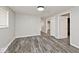 Spacious bedroom featuring wood-look floors, neutral paint, and ample closet space at 715 N Warman Ave, Indianapolis, IN 46222