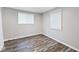 Cozy bedroom with wood-look floors, neutral walls, and natural light from the windows at 715 N Warman Ave, Indianapolis, IN 46222