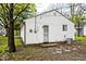 Exterior view of a white vinyl-sided home with a door and a small window at 715 N Warman Ave, Indianapolis, IN 46222