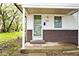Inviting home exterior featuring a covered porch with white pillars and a secure screen door at 715 N Warman Ave, Indianapolis, IN 46222