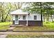 Charming single-story home with white siding, covered porch, and well-maintained front yard at 715 N Warman Ave, Indianapolis, IN 46222