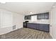 Charming kitchen featuring painted cabinets, modern appliances, and wood-look vinyl floors at 715 N Warman Ave, Indianapolis, IN 46222