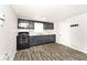Charming kitchen featuring painted cabinets, modern appliances, and wood-look vinyl floors at 715 N Warman Ave, Indianapolis, IN 46222
