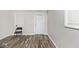 Bright room with wood-look floors, white walls, and plenty of natural light from the windows at 715 N Warman Ave, Indianapolis, IN 46222