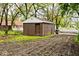 View of a shed with brown walls, a brown door, and a concrete foundation at 715 N Warman Ave, Indianapolis, IN 46222
