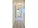 Bright hallway with carpeted floors and access to bedrooms at 7704 Winding Creek Dr, Indianapolis, IN 46236