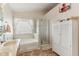 Bathroom with soaking tub, shower, and linen storage at 870 Harvest Lake Dr, Brownsburg, IN 46112