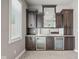 Basement wet bar with dark wood cabinets and granite countertops at 1023 Westview Point Dr, Columbus, IN 47201