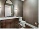Powder room with dark wood vanity and textured wallpaper at 1023 Westview Point Dr, Columbus, IN 47201