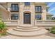 Grand entrance with stone archway, wrought iron balconies, and steps leading to the front door at 1023 Westview Point Dr, Columbus, IN 47201