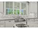 Modern kitchen with farmhouse sink, granite countertops, and mosaic backsplash at 1023 Westview Point Dr, Columbus, IN 47201
