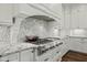 Elegant kitchen with white cabinetry, gas cooktop and a stylish range hood at 1023 Westview Point Dr, Columbus, IN 47201