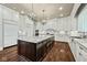 Large kitchen with white cabinets, granite island and hardwood floors at 1023 Westview Point Dr, Columbus, IN 47201