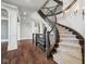 Elegant curved staircase with ornate railing and hardwood flooring at 1023 Westview Point Dr, Columbus, IN 47201